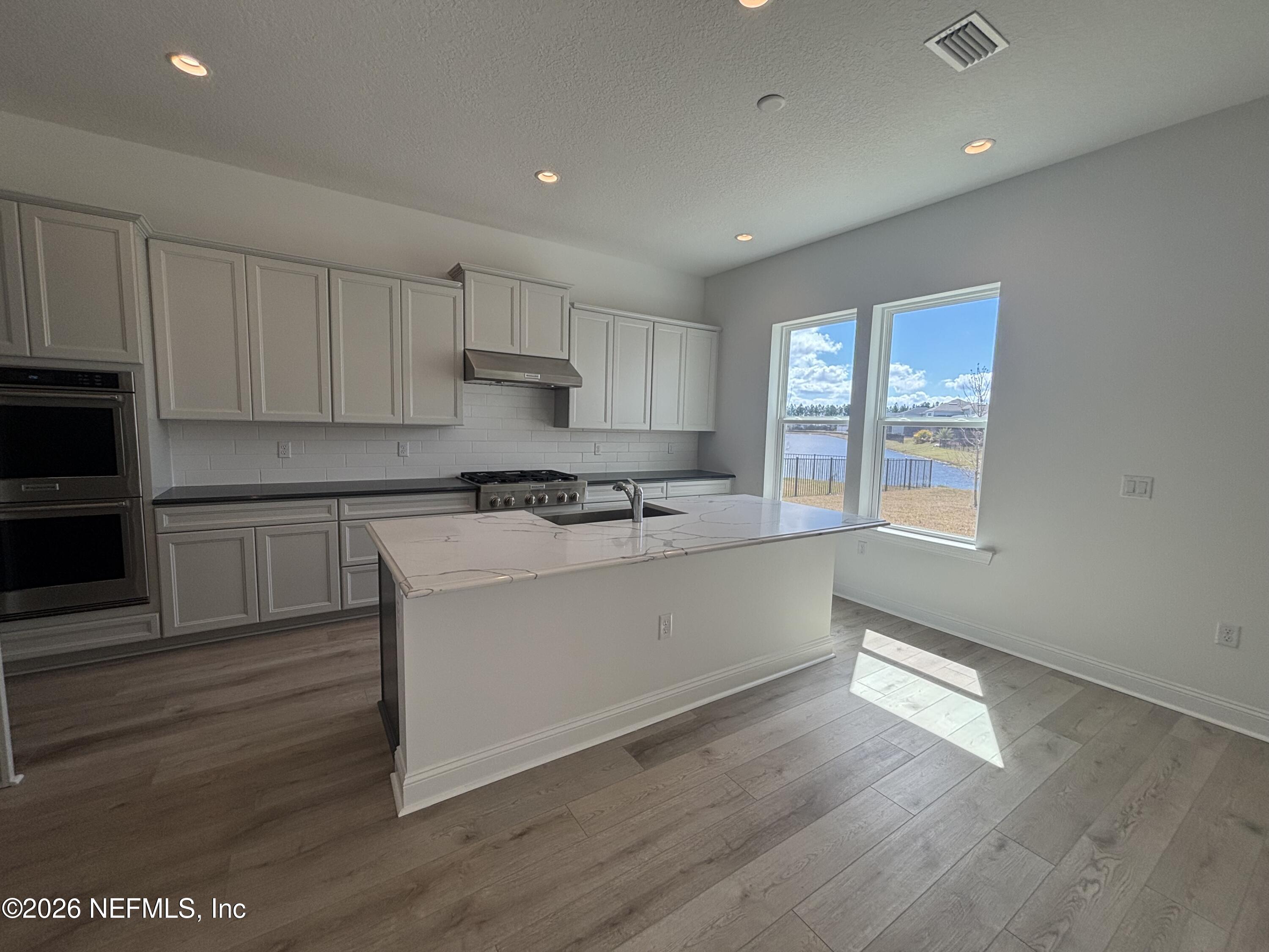 74 Sapling Terrace St. Johns, FL 32259 - Photo 3 of 39 a kitchen with granite countertop a stove a sink and a refrigerator