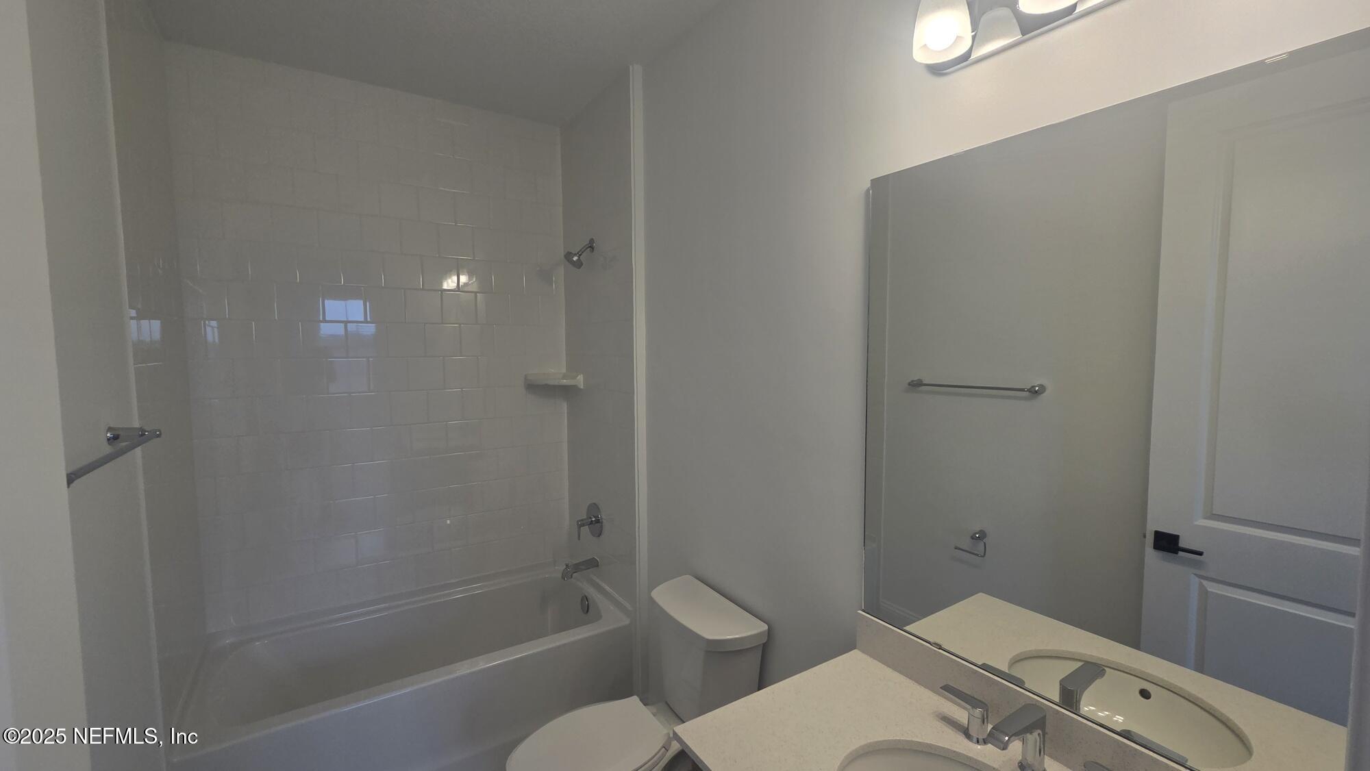 74 Sapling Terrace St. Johns, FL 32259 - Photo 39 of 49 a bathroom with a granite countertop toilet and a shower