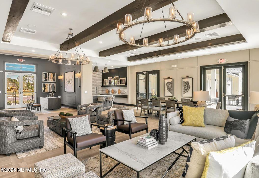 74 Sapling Terrace St. Johns, FL 32259 - Photo 8 of 49 a living room with furniture a chandelier and a dining table