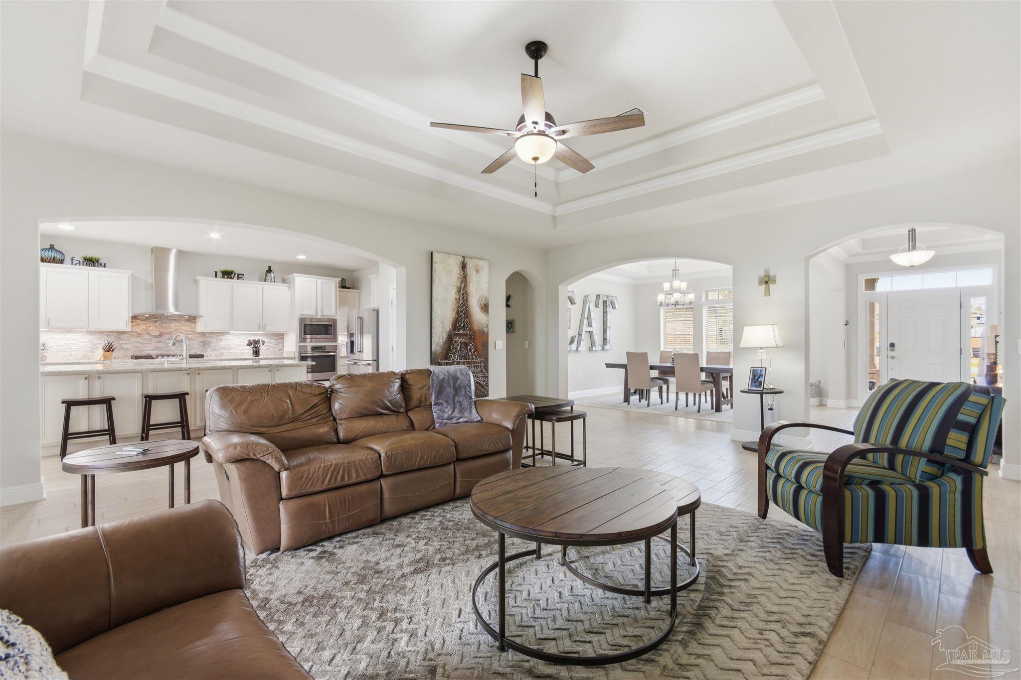2677 Tulip Hill Road Pace, FL 32571 - Photo 18 of 35 a living room with furniture kitchen and a chandelier