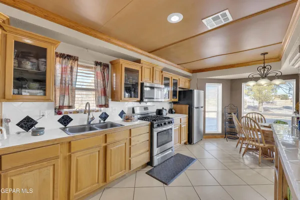 a kitchen with a sink and chairs