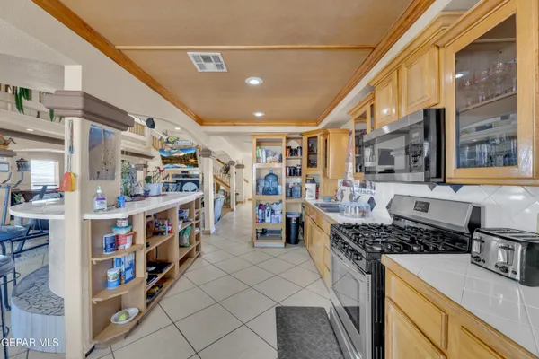 a kitchen with stainless steel appliances granite countertop a stove and cabinets