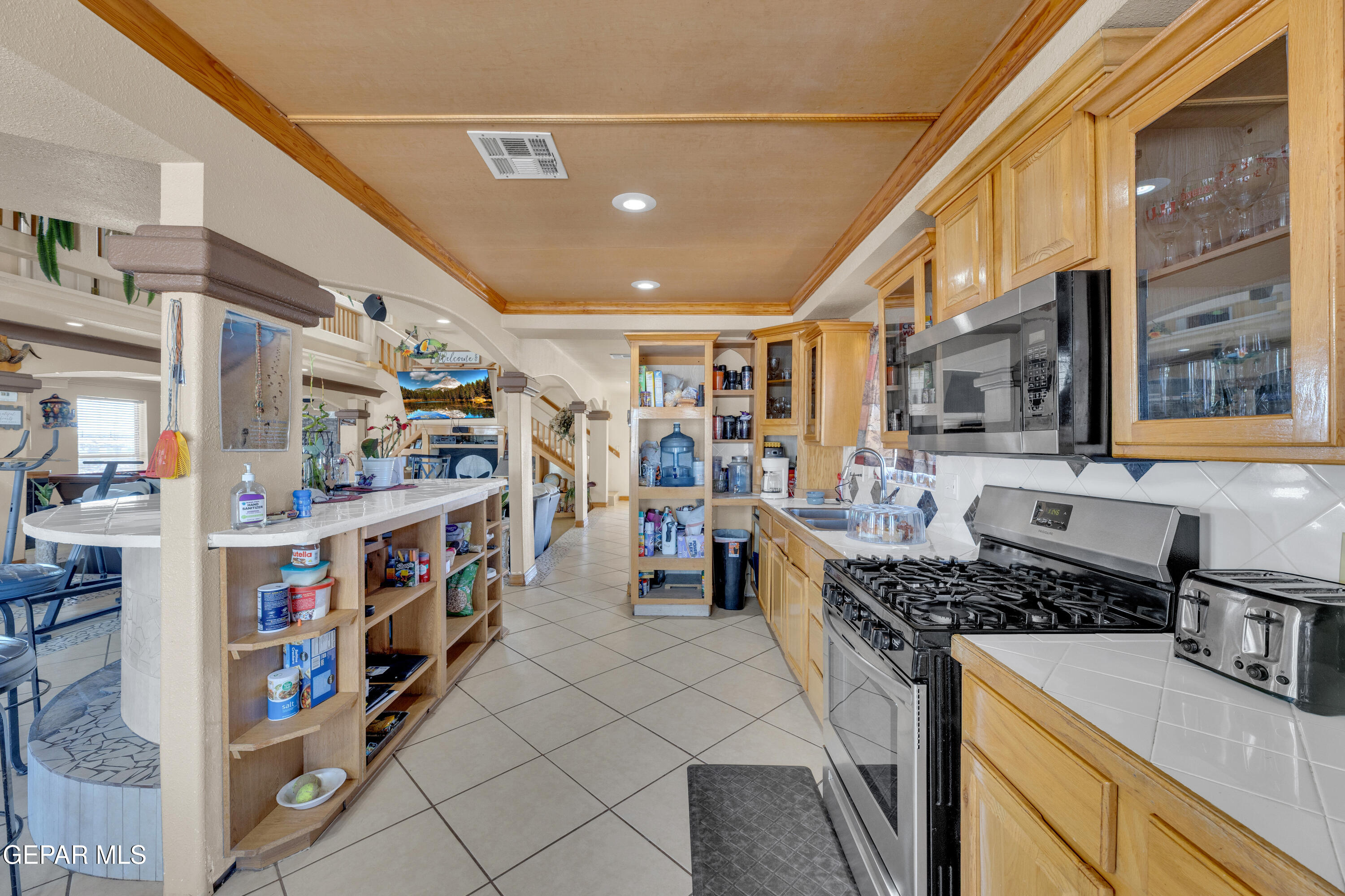 16020 Harrison Road El Paso, TX 79928 - Photo 16 of 56 a kitchen with stainless steel appliances granite countertop a stove and cabinets