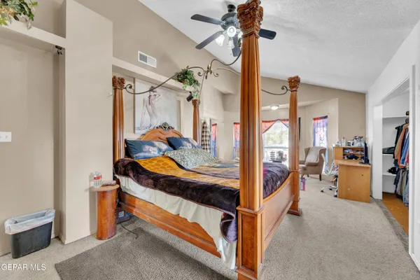 a bedroom with furniture and a large window