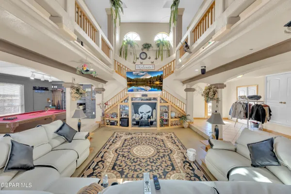 a living room with furniture and a chandelier