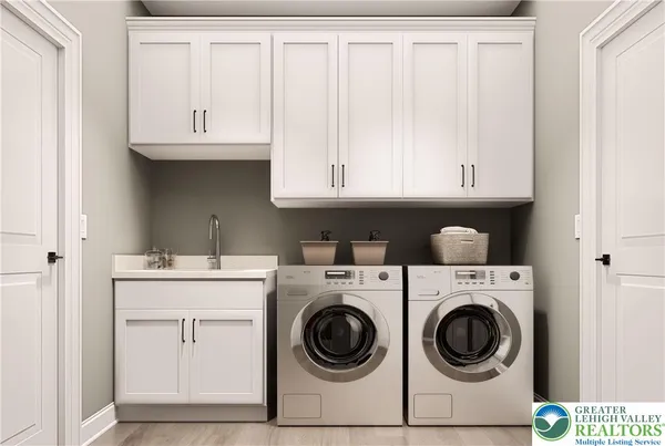 a utility room with sink dryer and washer