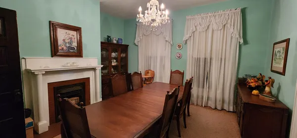 a dining room with furniture and chandelier