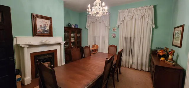 a dining room with furniture and chandelier