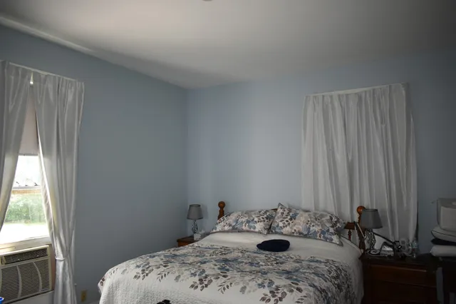 a bedroom with a bed and a window