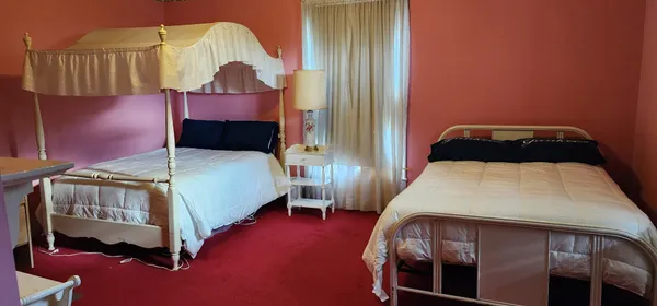 a bedroom with a bed a mirror and dresser