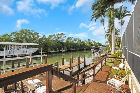 a view of a lake with couches chairs