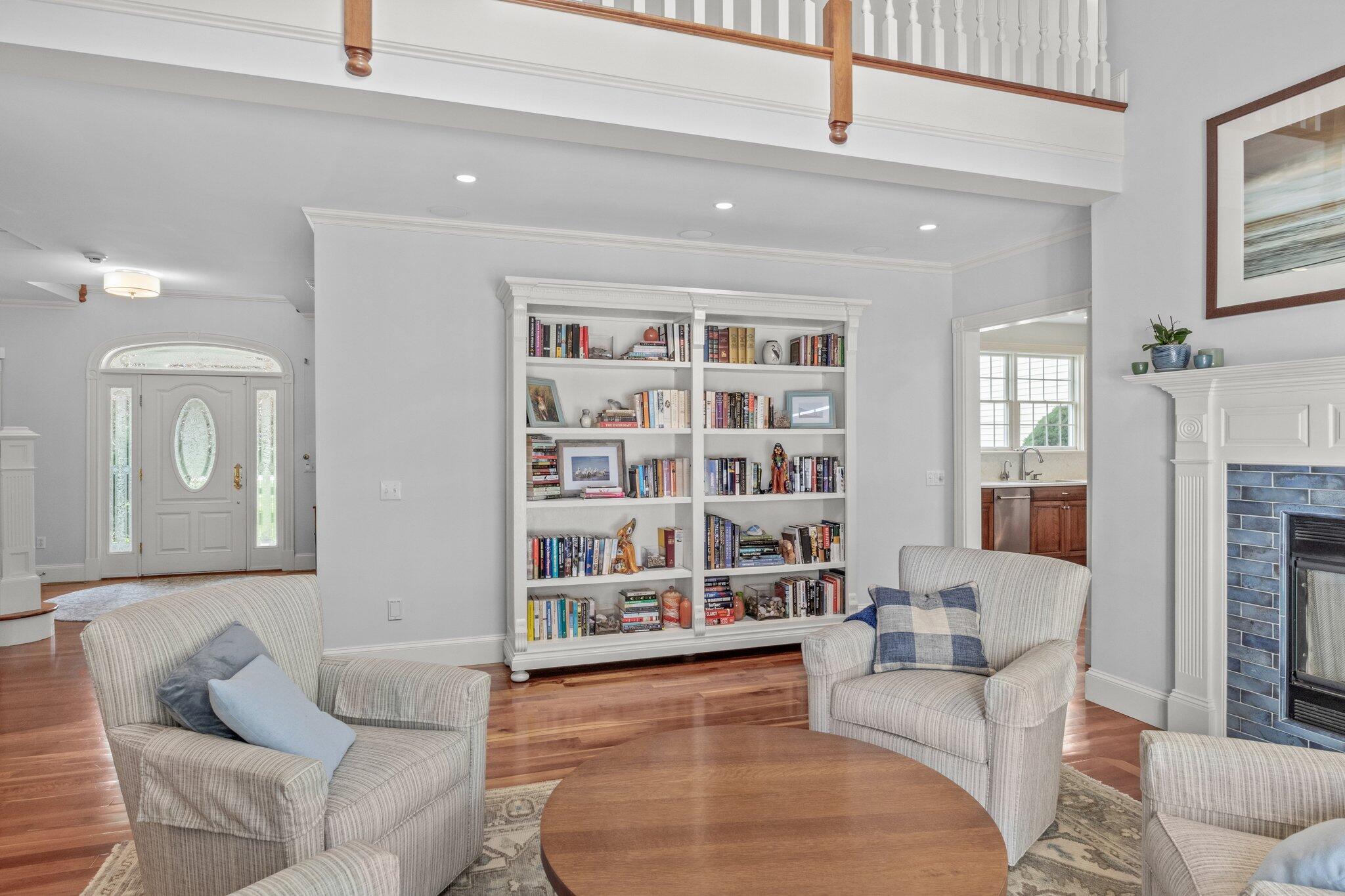 63 Farm Valley Road Osterville, MA 02655 - Photo 13 of 42 a living room with furniture and a book shelf