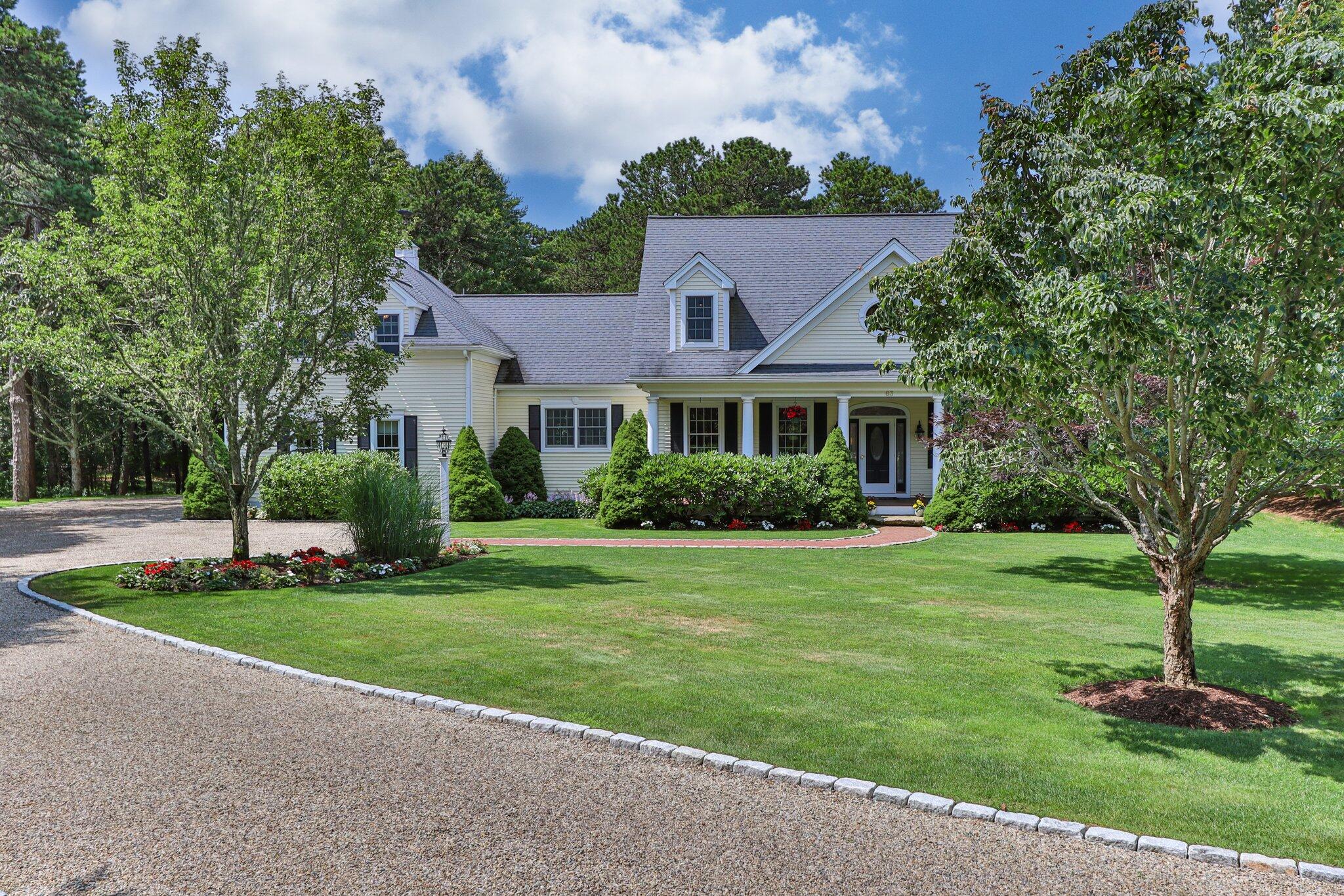 63 Farm Valley Road Osterville, MA 02655 - Photo 3 of 42 a front view of a house with a yard