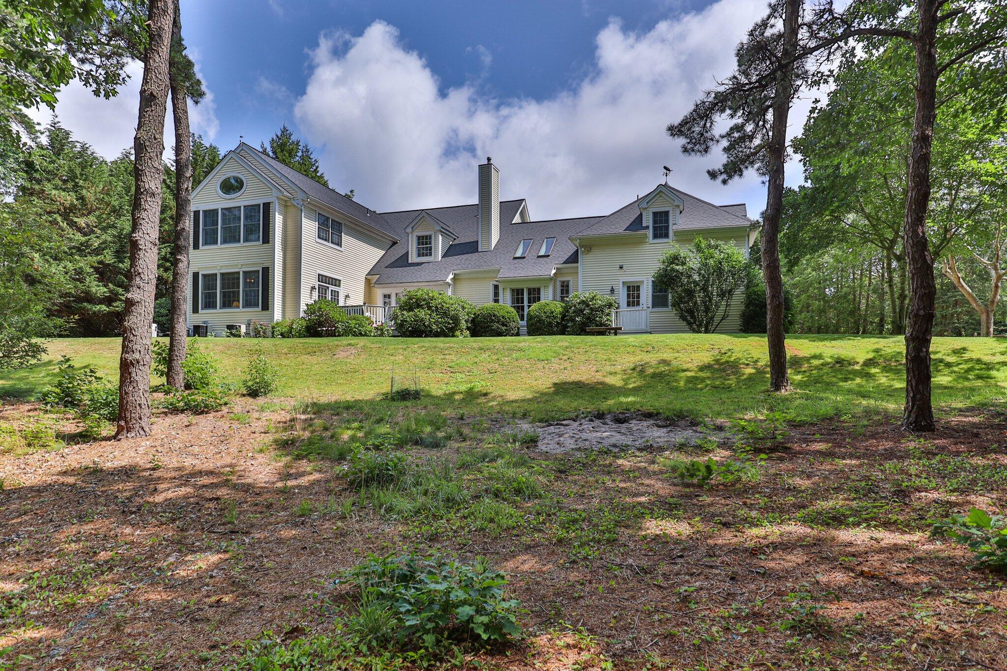 63 Farm Valley Road Osterville, MA 02655 - Photo 35 of 42 a front view of a house with a yard