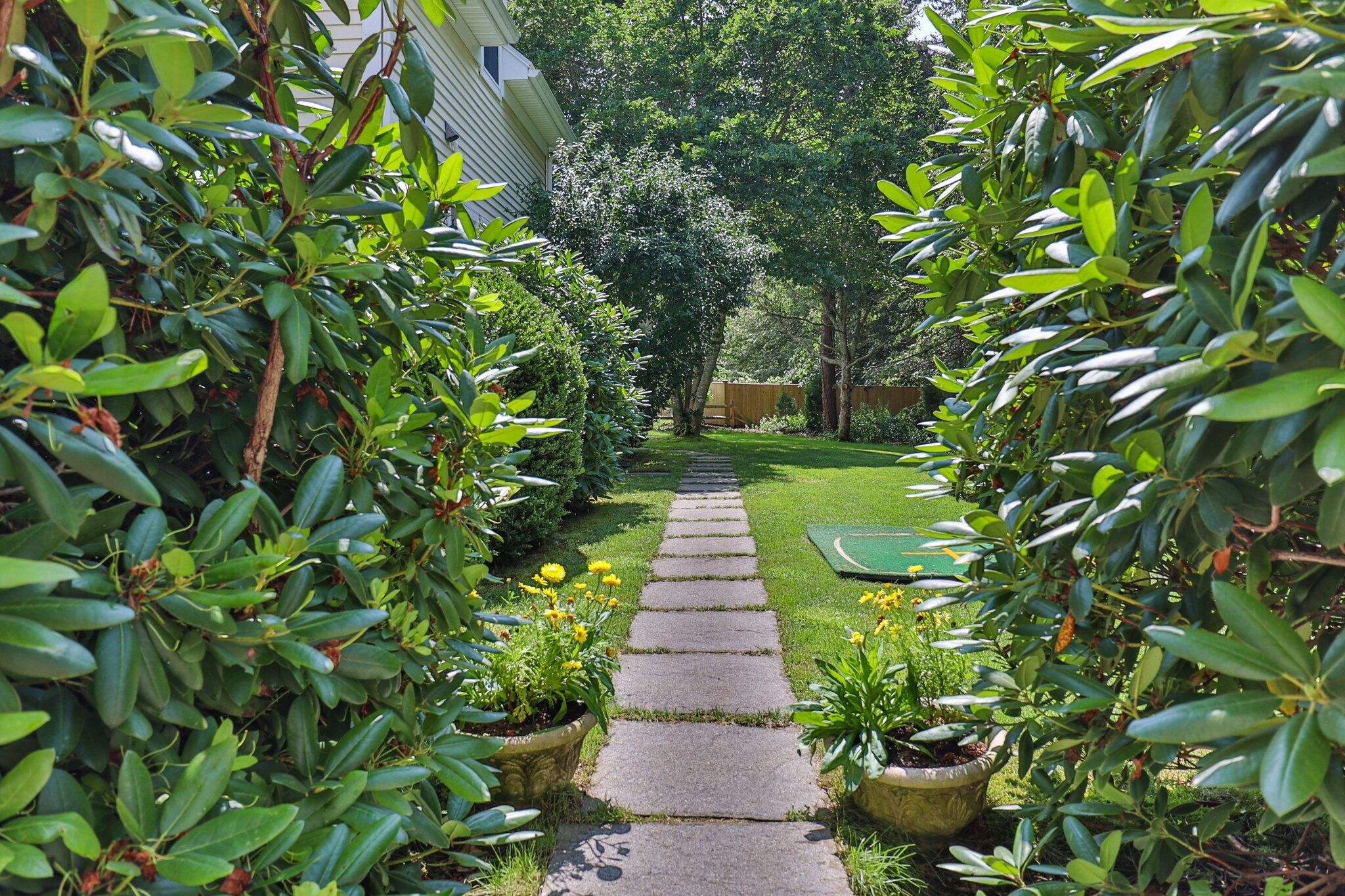 63 Farm Valley Road Osterville, MA 02655 - Photo 36 of 42 a view of a garden with plants and large trees