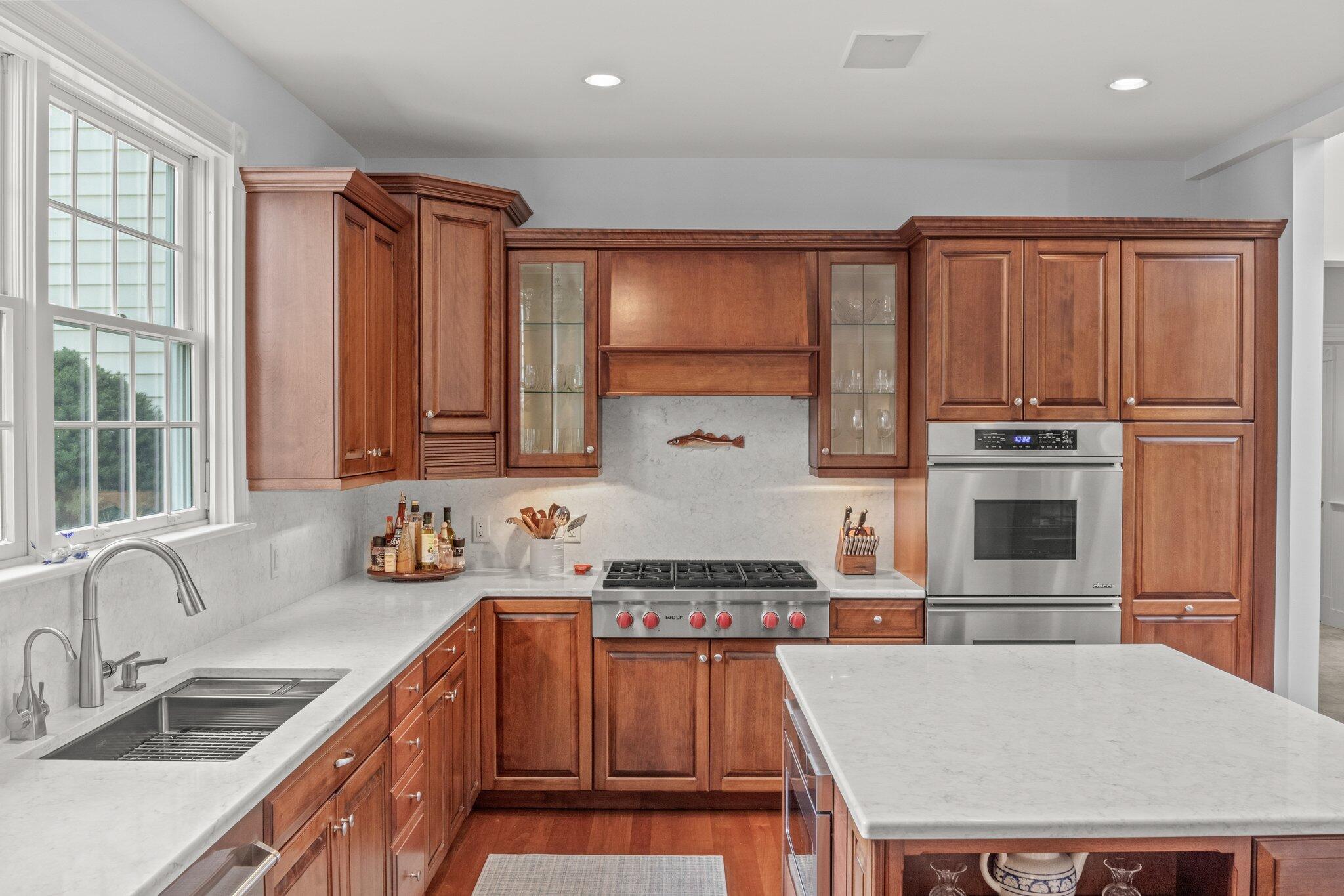 63 Farm Valley Road Osterville, MA 02655 - Photo 10 of 42 a kitchen with a stove a sink and a refrigerator