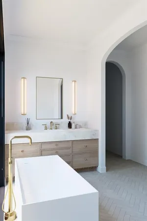 a bathroom with a large tub sink vanity and windows