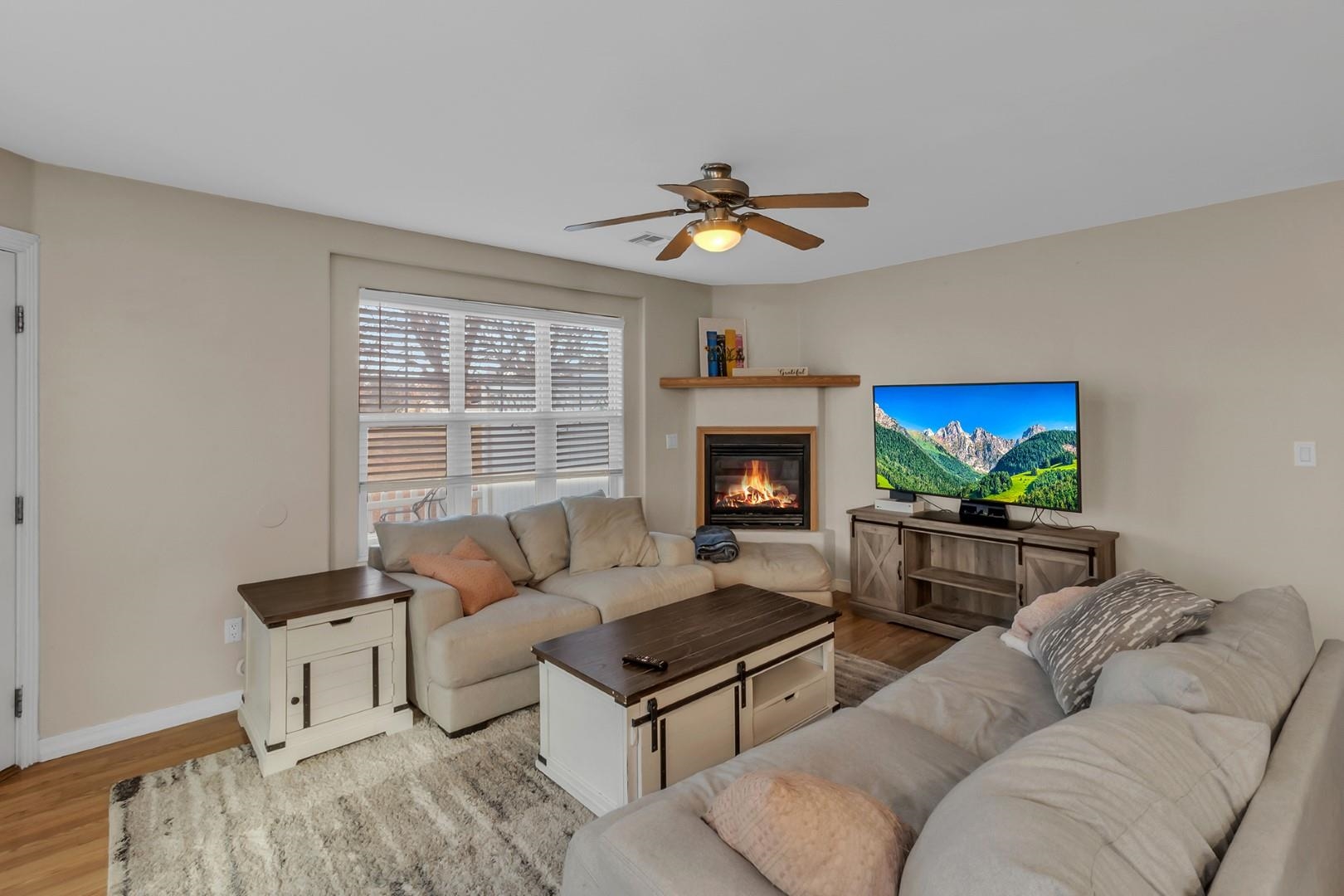 1209 Windsor Park Drive Fruita, CO 81521 - Photo 3 of 26 a living room with furniture a fireplace and a flat screen tv