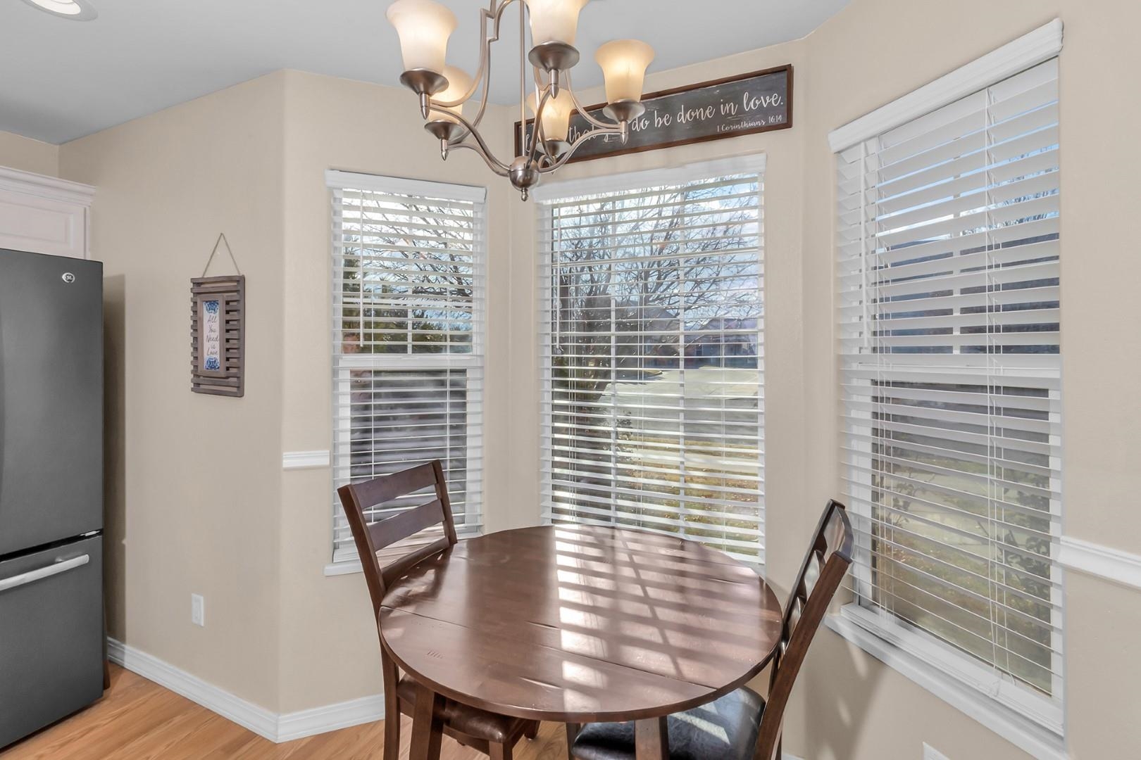 1209 Windsor Park Drive Fruita, CO 81521 - Photo 5 of 26 a view of a dining room with furniture window and wooden floor