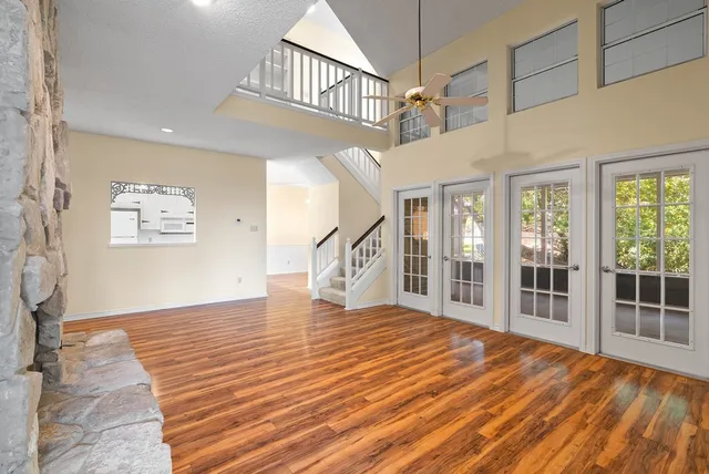 a big room with wooden floor and windows