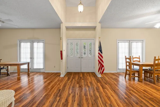 a view of empty room with wooden floor and furniture