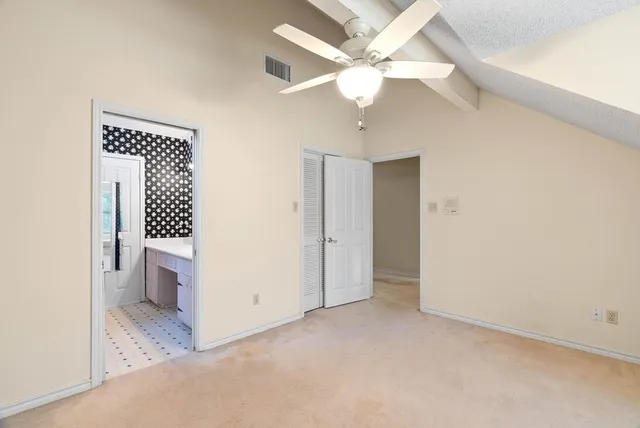 a view of a hallway with a bathroom