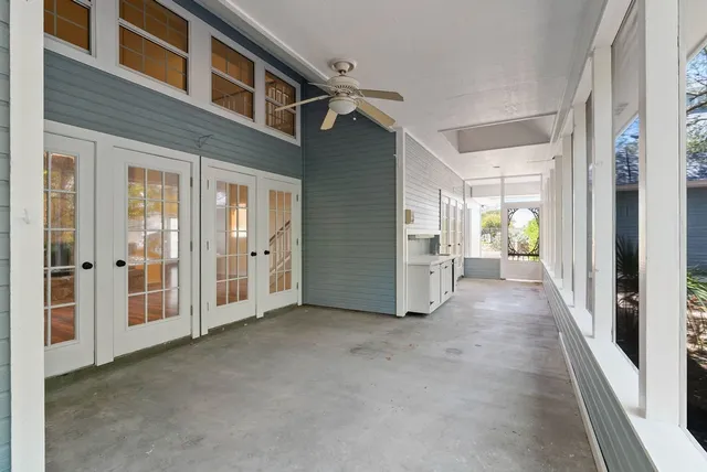 a view of a hallway with wooden shelves
