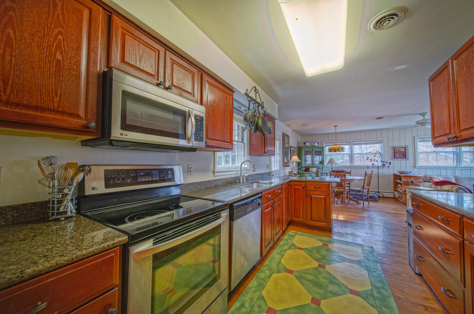 3120 Stoneridge Road Southwest Roanoke, VA 24014 - Photo 12 of 35 a kitchen with stainless steel appliances granite countertop a stove a sink and a microwave