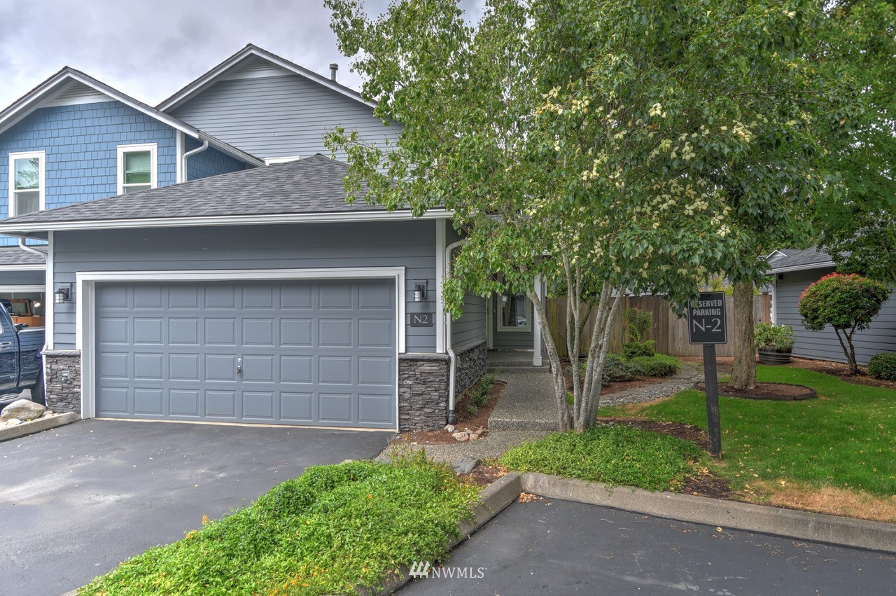 2201 192nd Street Southeast, Unit N2 Bothell, WA 98012 - Photo 1 of 39 front view of a house with a yard and a garage