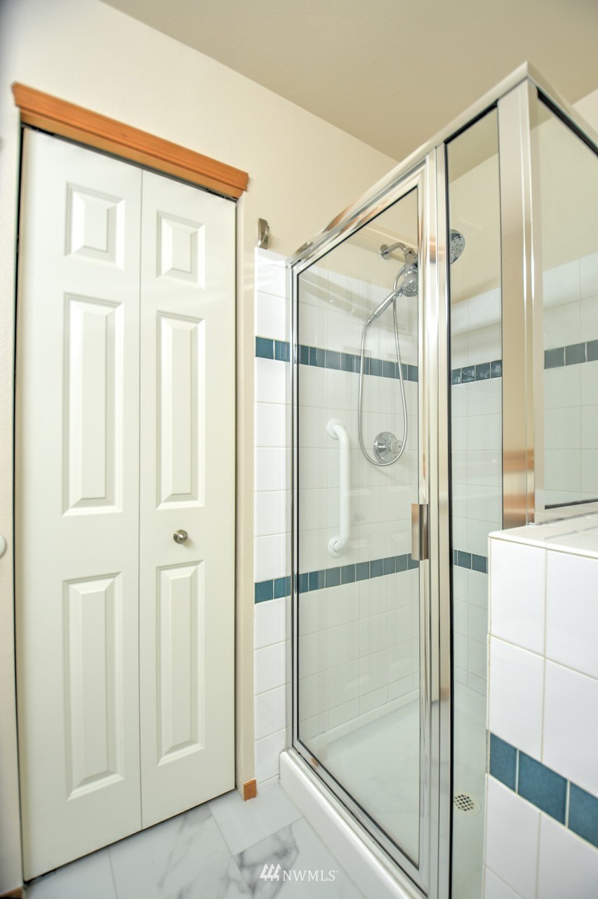 2201 192nd Street Southeast, Unit N2 Bothell, WA 98012 - Photo 23 of 39 a bathroom with a glass shower door
