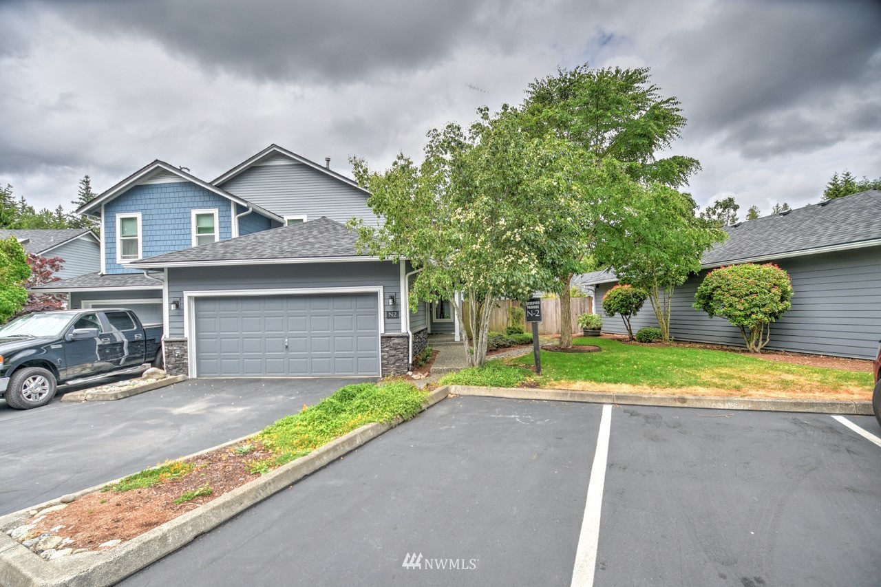 2201 192nd Street Southeast, Unit N2 Bothell, WA 98012 - Photo 36 of 39 a front view of a house with a yard and garage