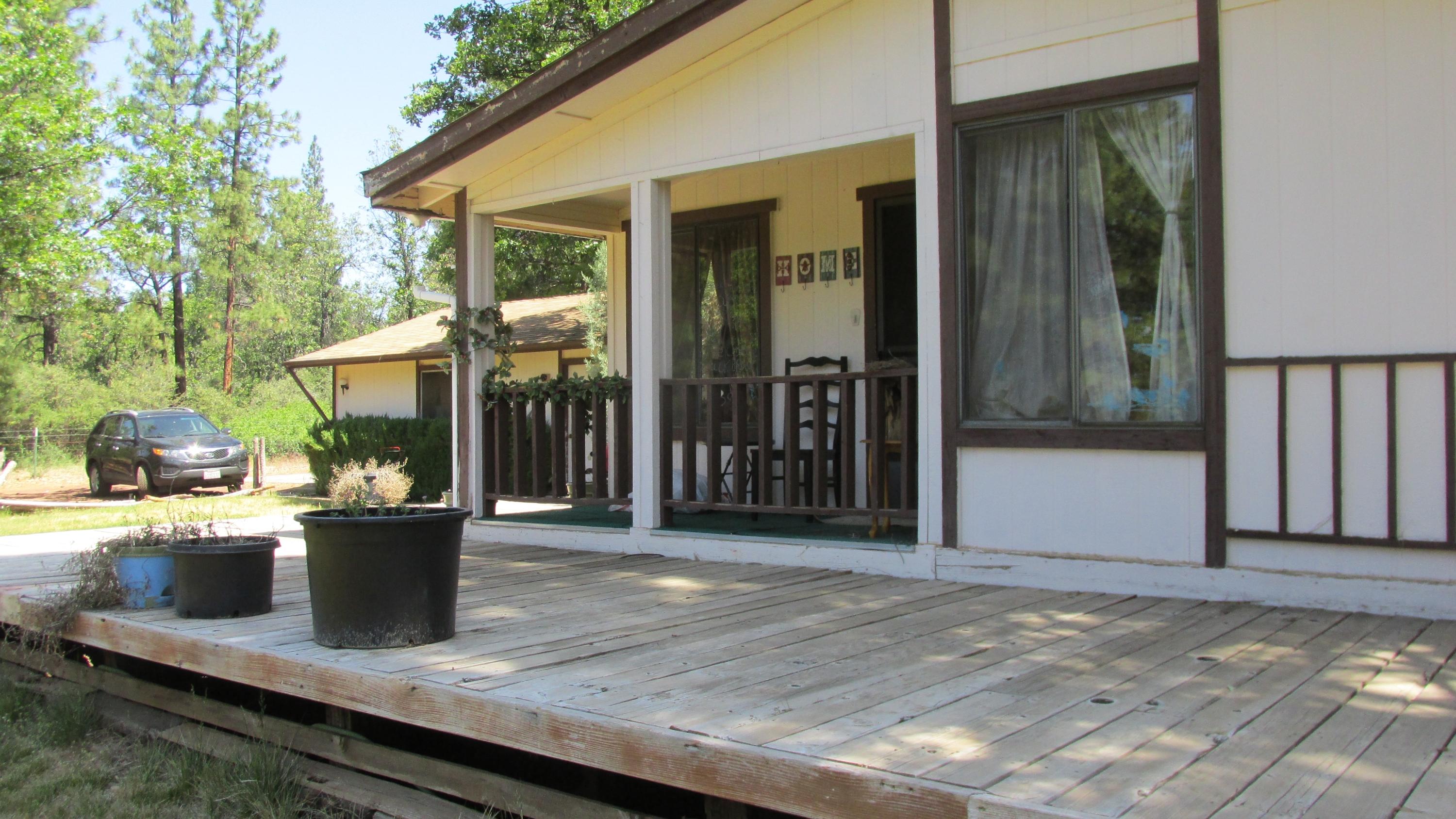 29405 Day Road McArthur, CA 96056 - Photo 2 of 45 a view of a porch with wooden floor and floor to ceiling window