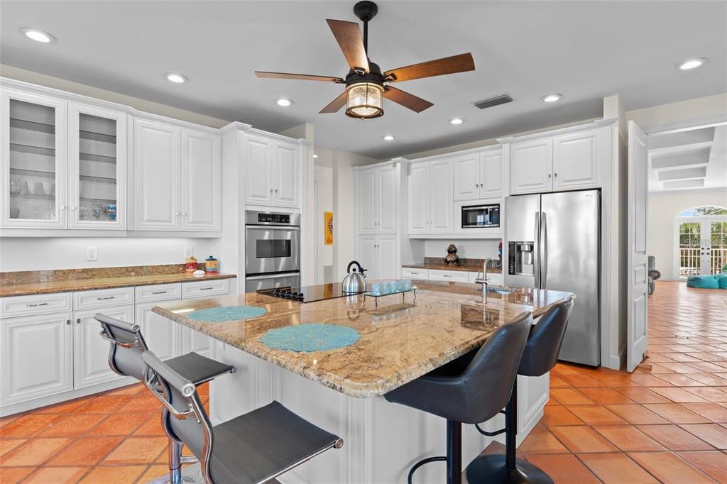 63 Palm Drive Placida, FL 33946 - Photo 11 of 54 a kitchen with stainless steel appliances granite countertop a stove refrigerator sink and cabinets