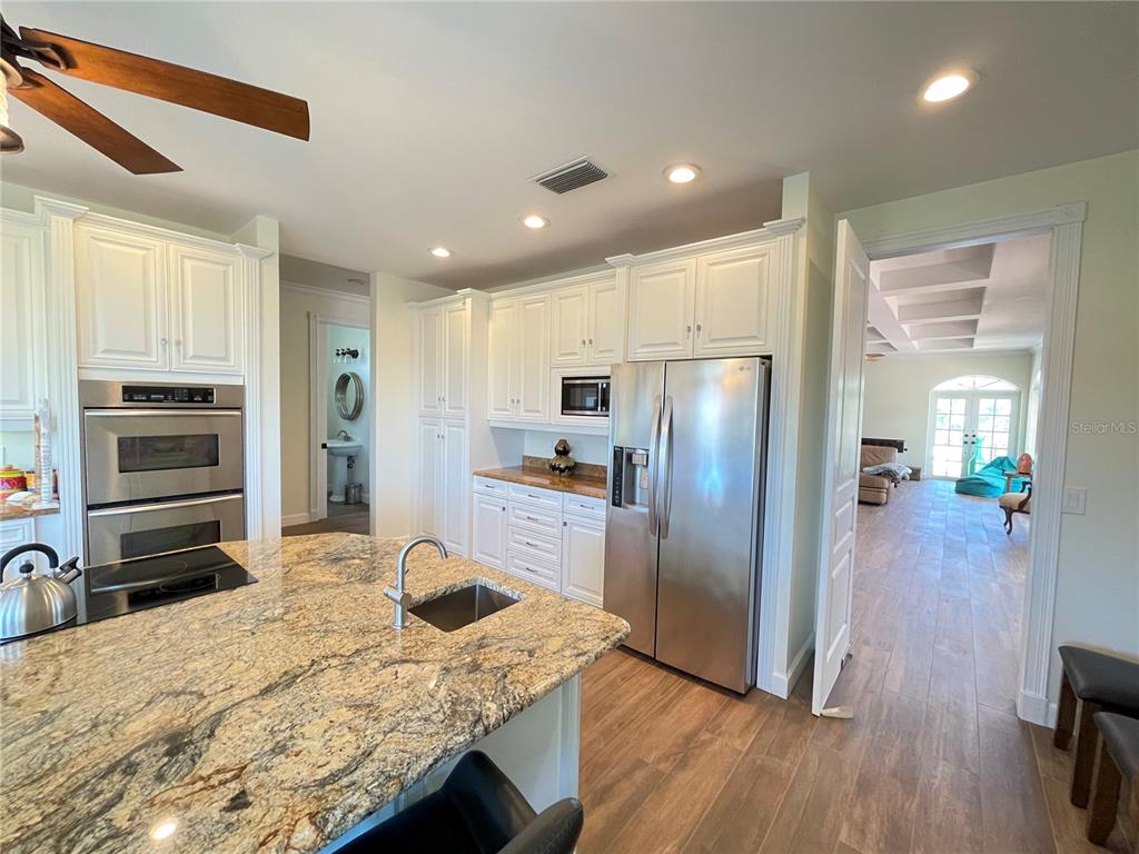 63 Palm Drive Placida, FL 33946 - Photo 12 of 54 a kitchen with granite countertop a refrigerator and a sink