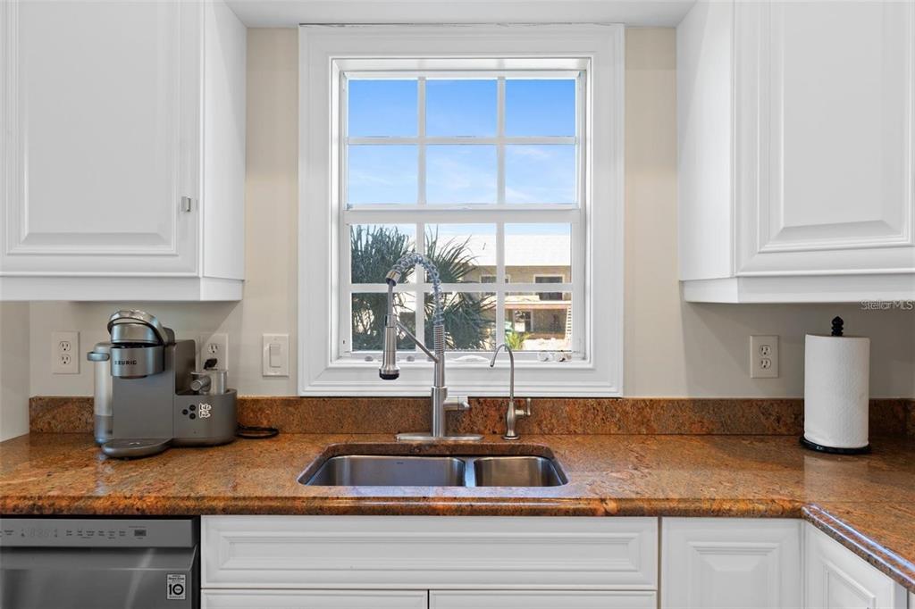 63 Palm Drive Placida, FL 33946 - Photo 15 of 54 a kitchen with granite countertop a sink and a window