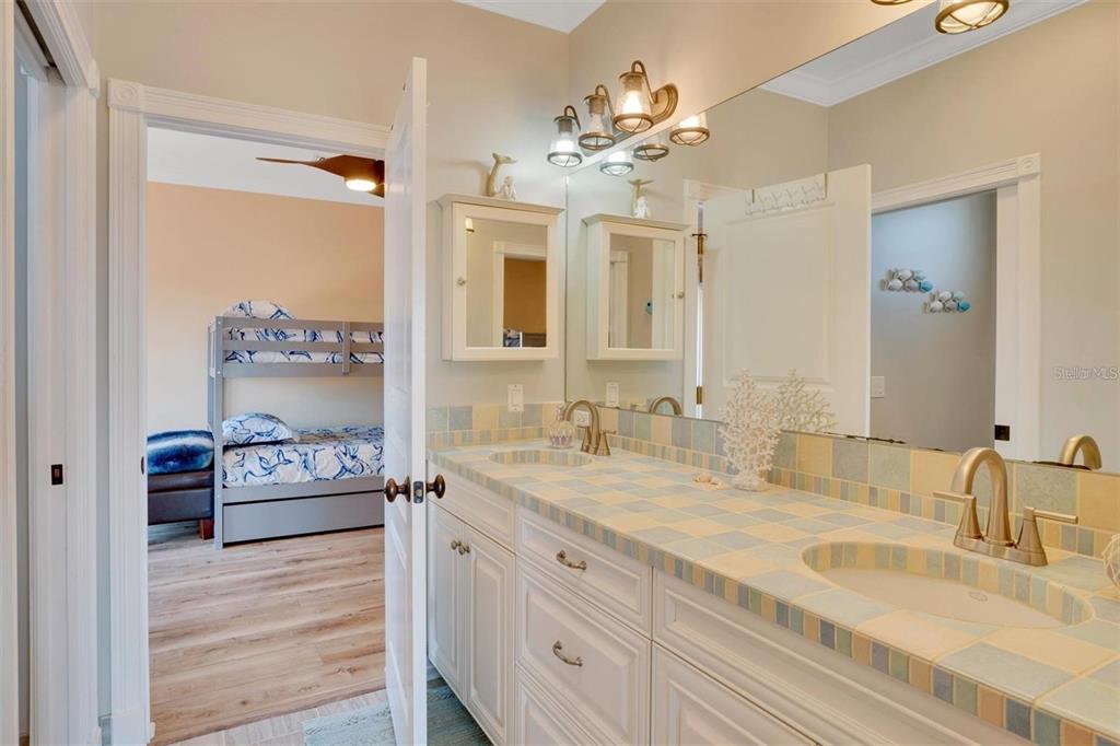 63 Palm Drive Placida, FL 33946 - Photo 26 of 54 a spacious bathroom with a granite countertop sink a mirror and a shower