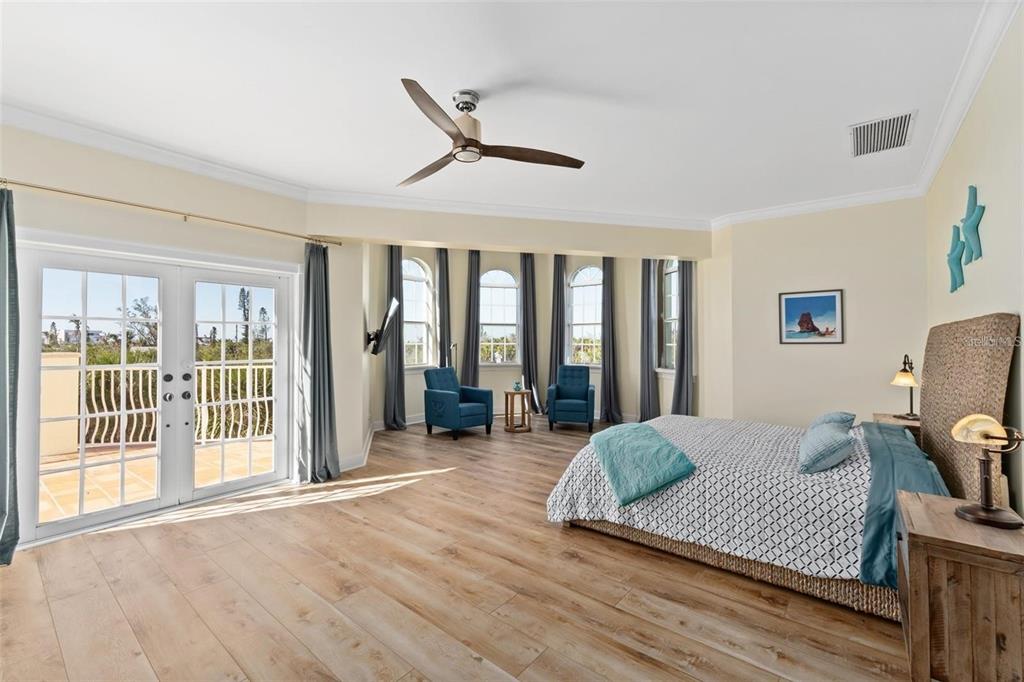 63 Palm Drive Placida, FL 33946 - Photo 29 of 54 a spacious bedroom with a bed and glass walk in closet