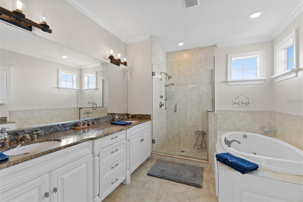 63 Palm Drive Placida, FL 33946 - Photo 33 of 54 a spacious bathroom with a granite countertop sink mirror and bathtub