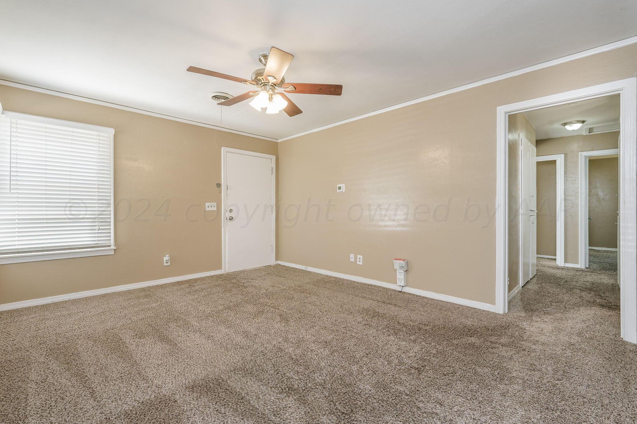 4108 South Travis Street Amarillo, TX 79110 - Photo 3 of 15 a view of an empty room with a window