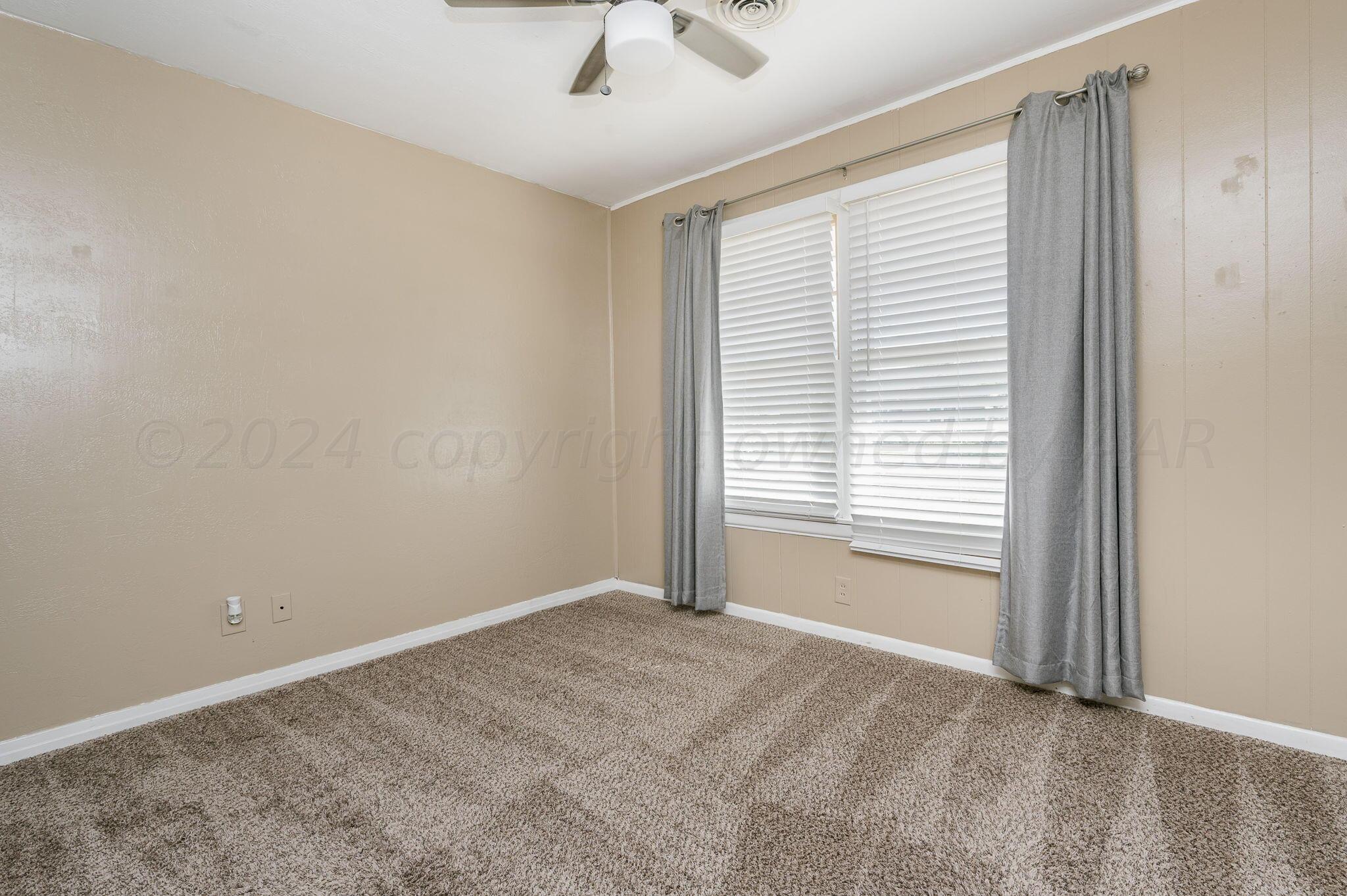 4108 South Travis Street Amarillo, TX 79110 - Photo 10 of 15 a view of an empty room with a window