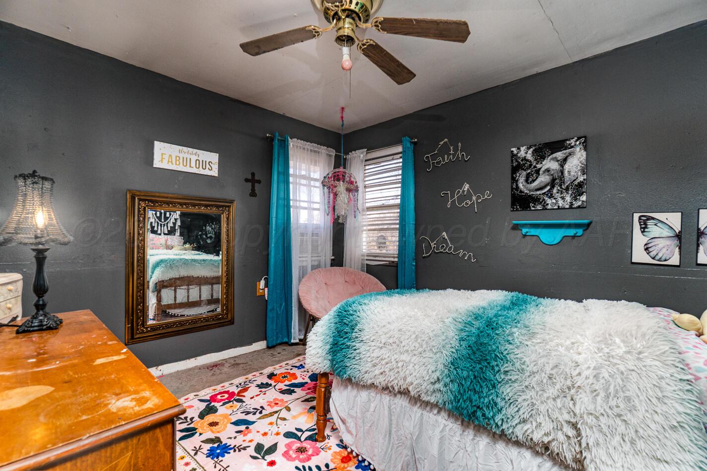 11 Travis Circle Tulia, TX 79088 - Photo 18 of 21 a bedroom with a bed and dresser with chair