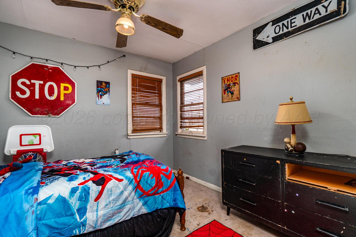 11 Travis Circle Tulia, TX 79088 - Photo 19 of 21 a bedroom with a bed and a lamp on dresser