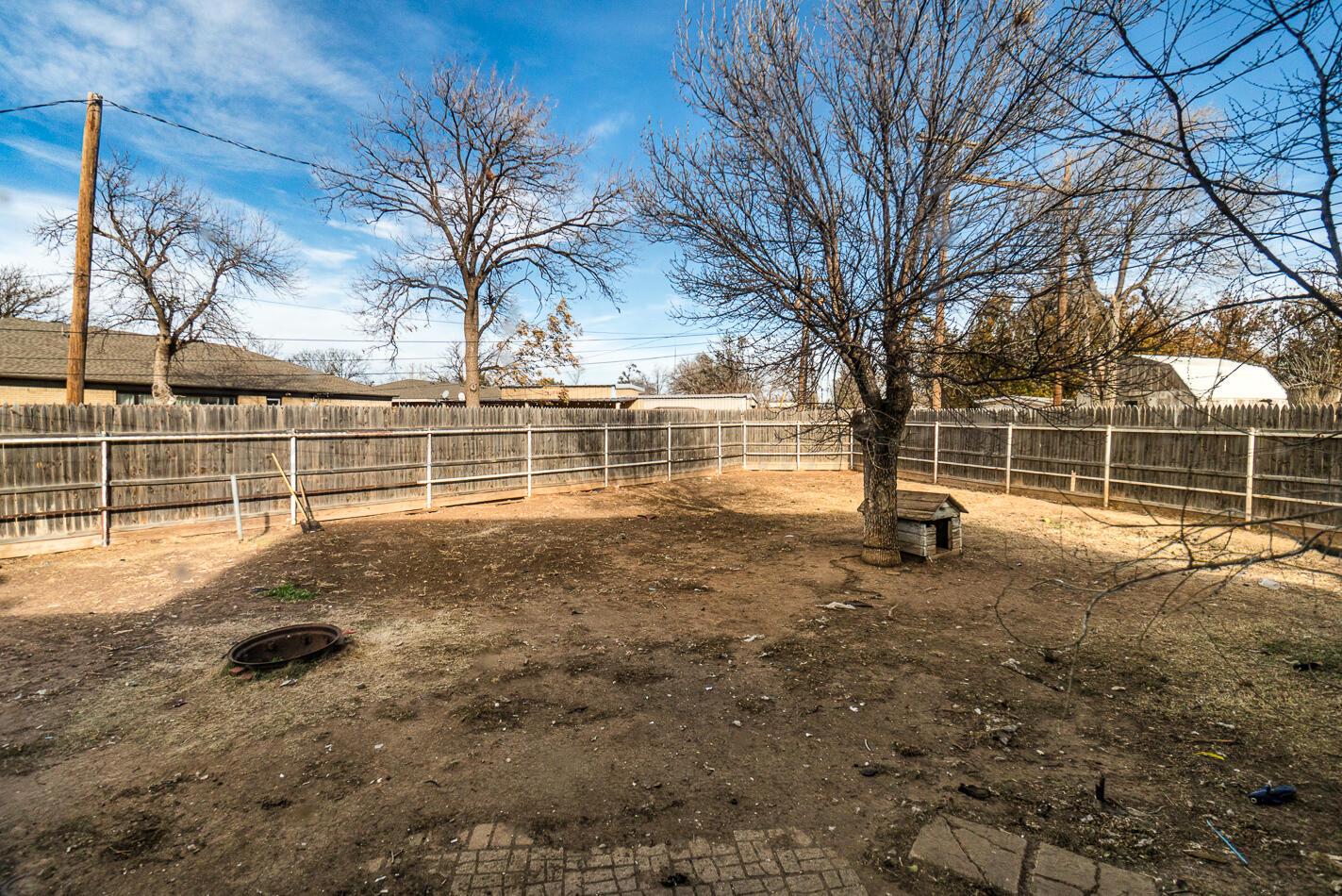 11 Travis Circle Tulia, TX 79088 - Photo 21 of 21 a view of a yard with wooden fence