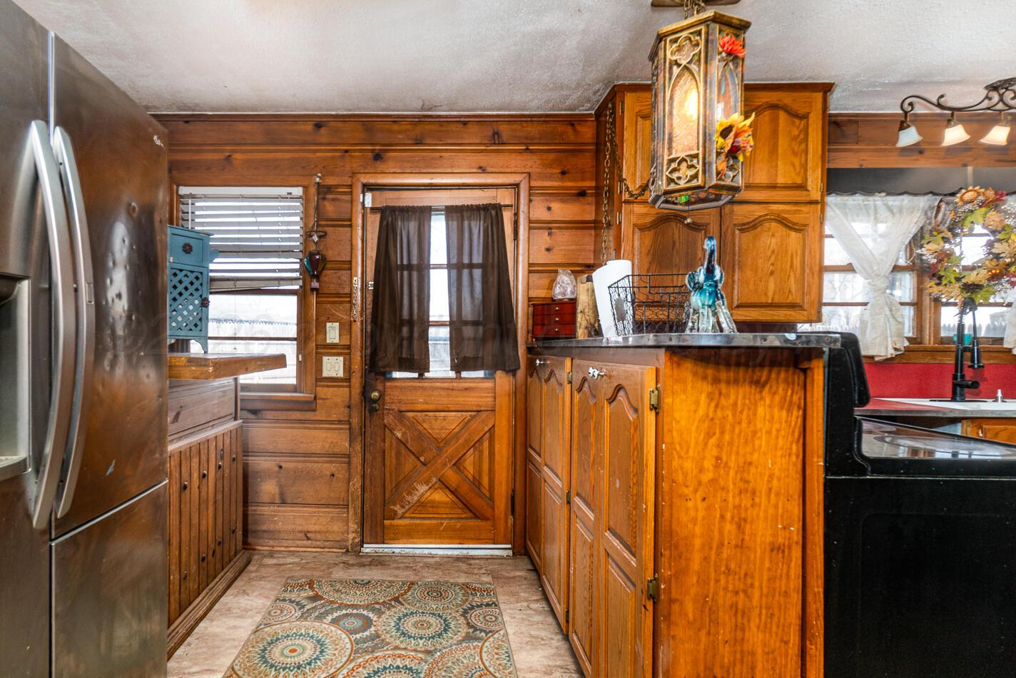 11 Travis Circle Tulia, TX 79088 - Photo 10 of 21 a view of a living room with a refrigerator and wooden floor