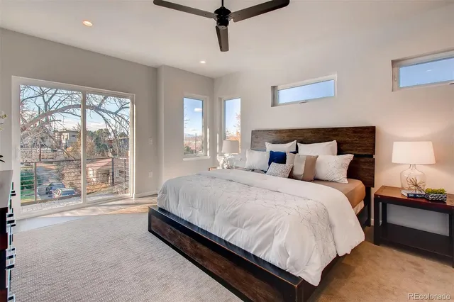 a large bed sitting in a bedroom next to a window