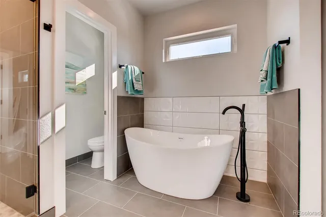 a white bath tub sitting next to a white toilet
