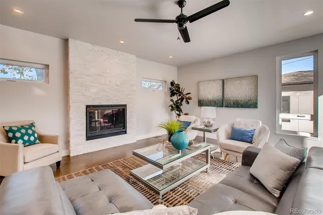 a living room with furniture and a fireplace