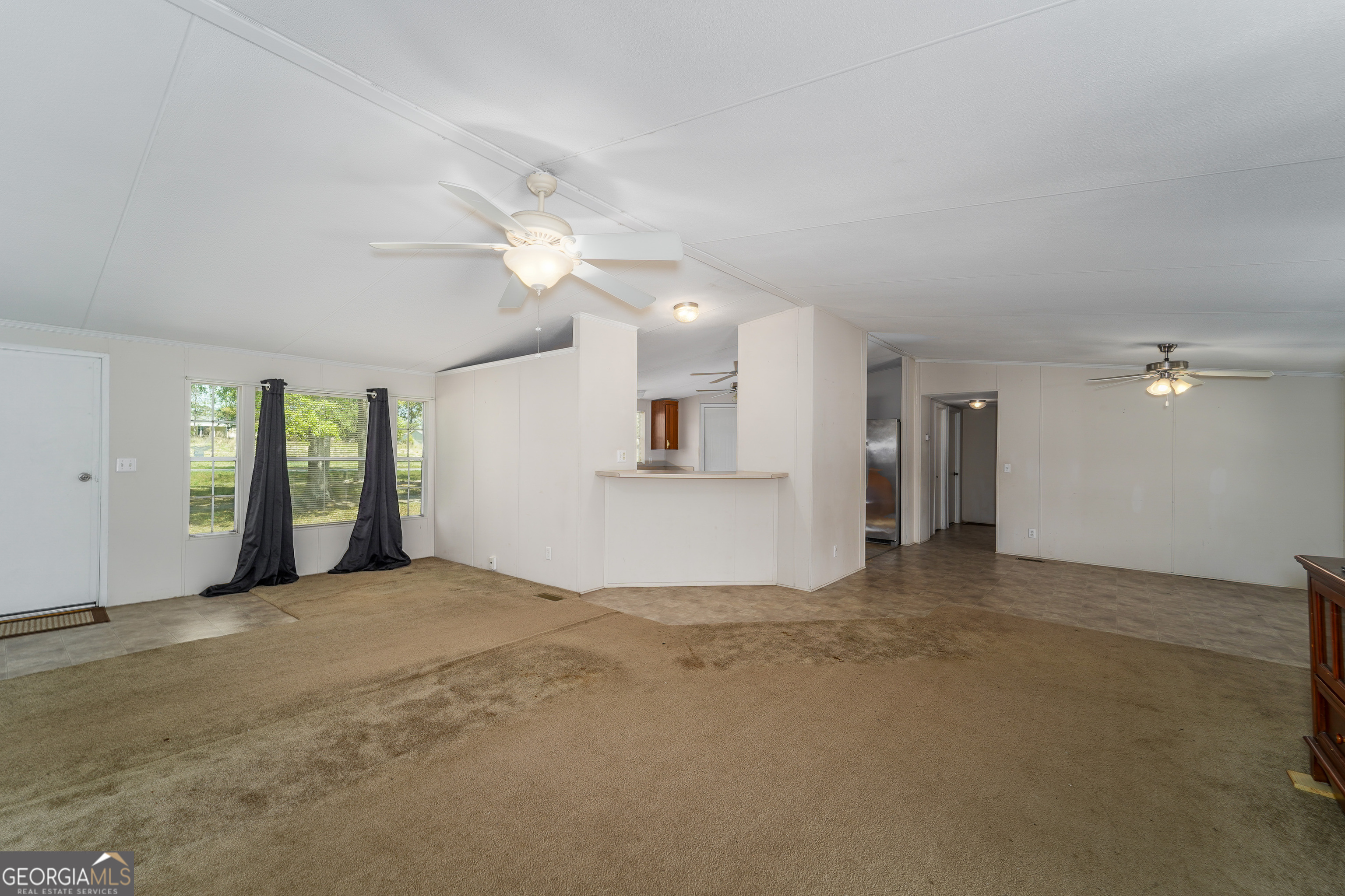 3642 Tanner Lane Waycross, GA 31503 - Photo 24 of 36 an empty room with windows and fan