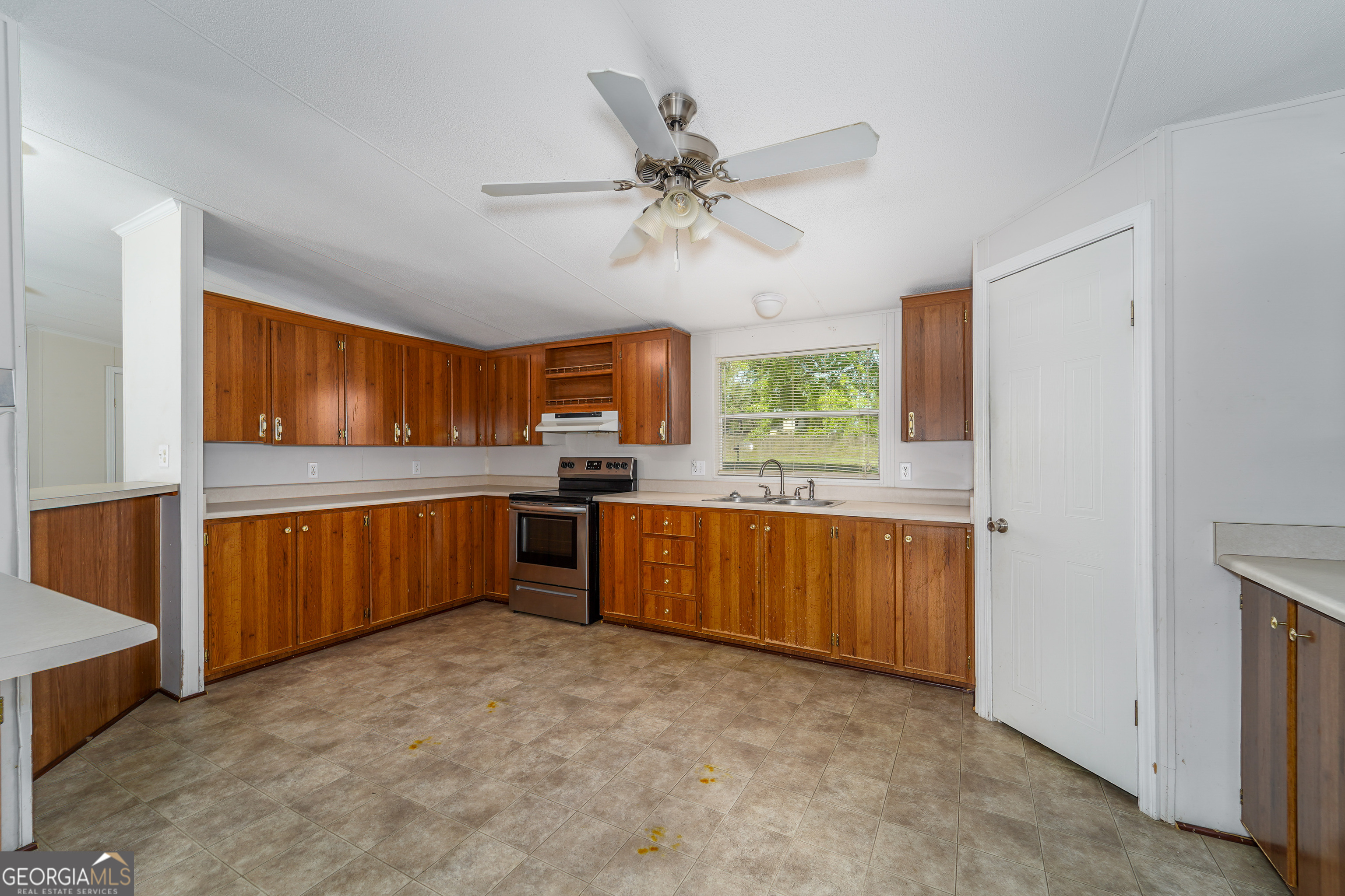 3642 Tanner Lane Waycross, GA 31503 - Photo 26 of 36 a large kitchen with a window and stainless steel appliances