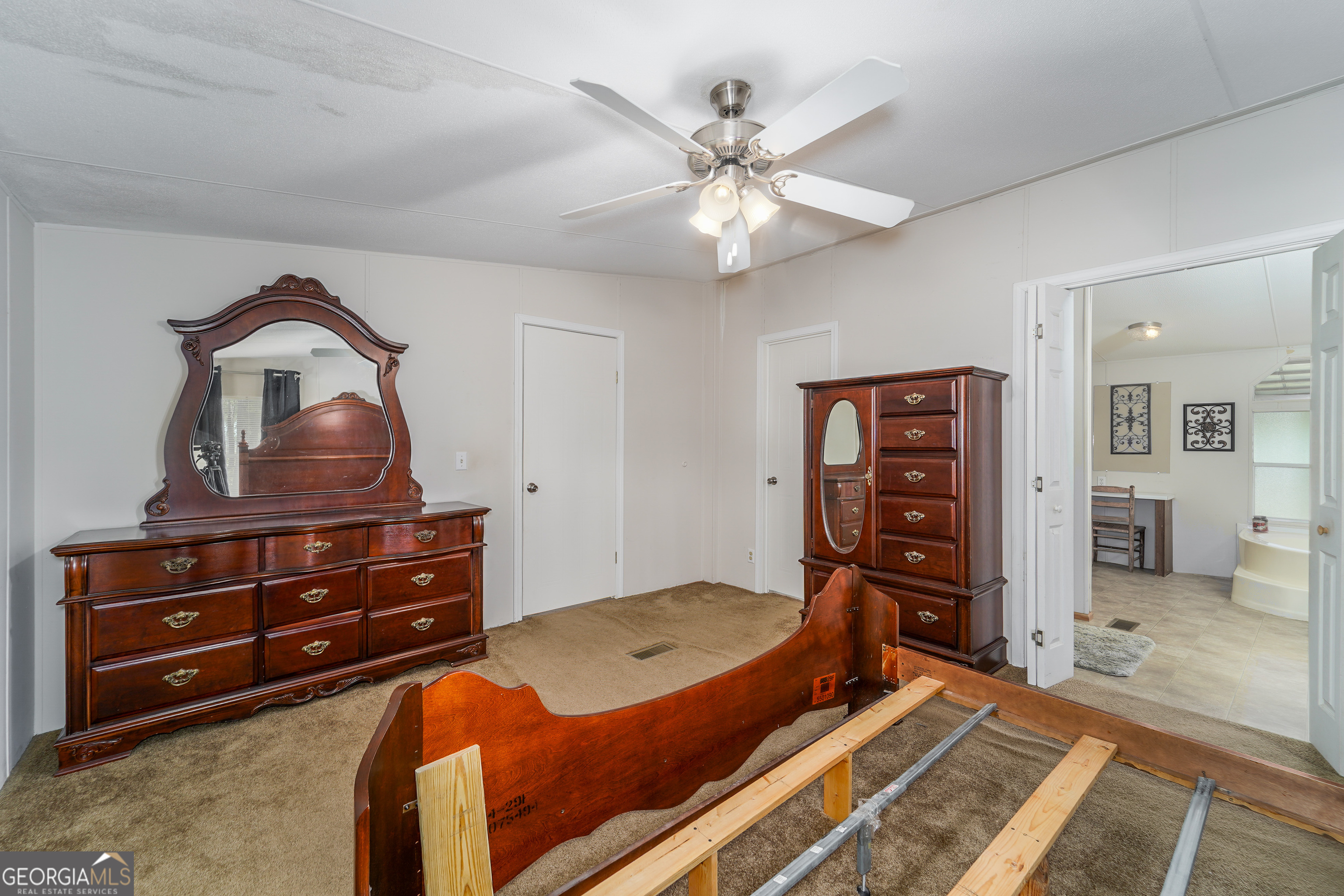 3642 Tanner Lane Waycross, GA 31503 - Photo 29 of 36 a bedroom with a bed and a dresser